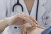 A doctor checks someone's pulse