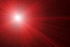 An image showing red laser beams on black
