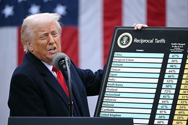 US President Donald Trump holds a chart as he delivers remarks on reciprocal tariffs during an event in the Rose Garden