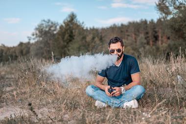 An image showing a man vaping