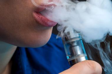 Young female vaping e-cigarette