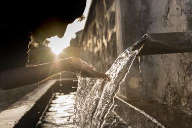 Person drinking water from a water pipe