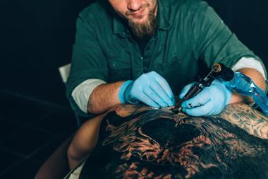 tattoo master artist makes a tattoo. Closeup