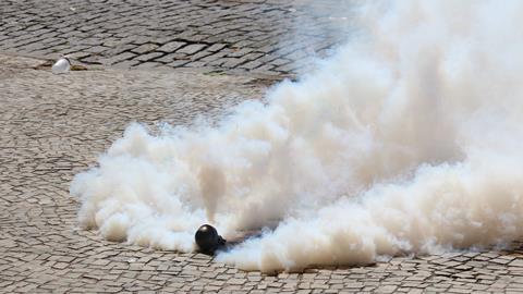 Tear gas bomb exploding on the floor.